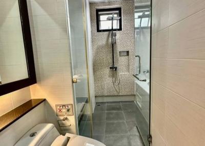 Modern bathroom with walk-in shower and stylish tiling