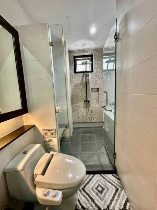 Modern bathroom with walk-in shower and stylish tiling