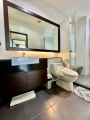 Modern bathroom interior with large mirror and glass shower cubicle