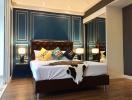Elegant bedroom with blue walls and dark wood flooring