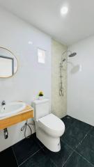 Modern bathroom interior with white walls and dark floor tiles