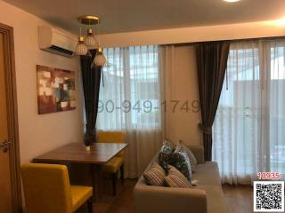 Cozy living room with dining area and large windows