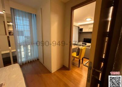 Cozy bedroom with view of the living area and balcony