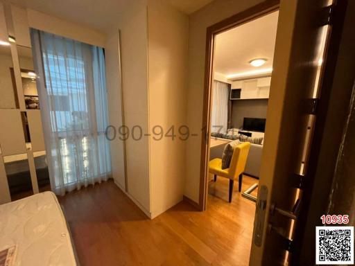 Cozy bedroom with view of the living area and balcony