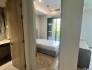 Modern bedroom with en suite bathroom and hardwood floors