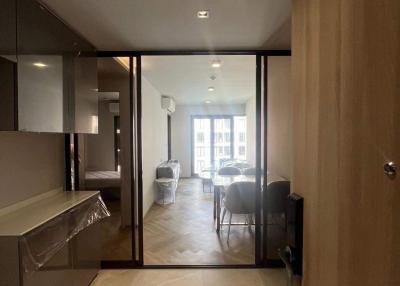 Interior view of a modern apartment showing an open door leading to the living area