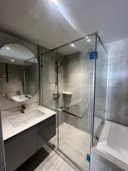 Modern bathroom with glass shower enclosure and sleek fixtures