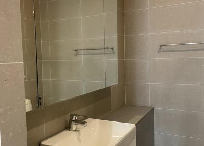 Modern bathroom with a well-lit vanity and neutral color scheme