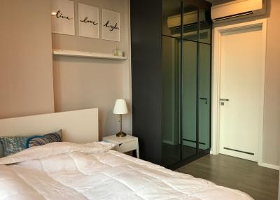 Cozy modern bedroom with air conditioning and glass sliding wardrobe doors