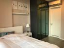 Cozy modern bedroom with air conditioning and glass sliding wardrobe doors