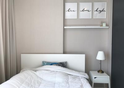 Cozy bedroom with decorative wall art and natural light