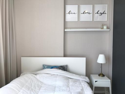 Cozy bedroom with decorative wall art and natural light