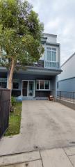 Contemporary two-story house exterior with a balcony and driveway