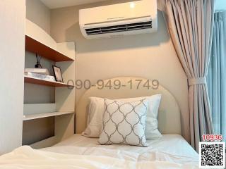 Cozy bedroom with air conditioning and built-in shelving
