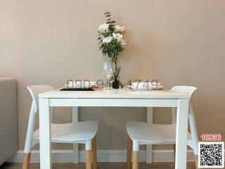 Minimalist dining area with white table and chairs