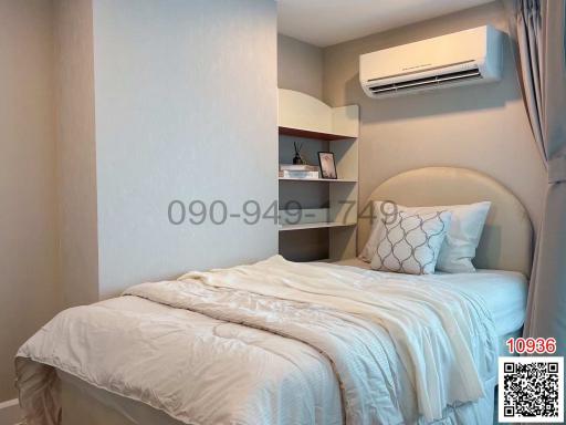 Cozy bedroom interior with queen-sized bed and air conditioning