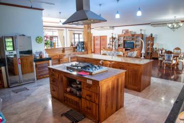 Spacious kitchen with modern appliances and wooden cabinetry