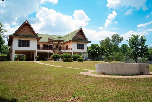 Spacious two-story house with large front lawn and clear skies