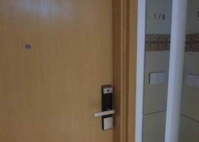 Wooden front door with modern lock partially open to an interior space