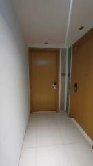 Interior hallway with tiled floor and wooden doors