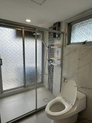 Modern bathroom with glass shower and marble tiles