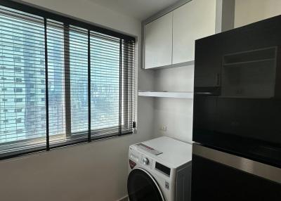 Compact space with washing machine, window blinds, and black appliances