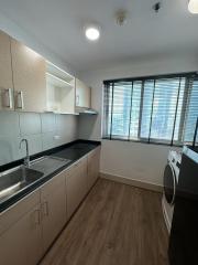 Modern kitchen with stainless steel appliances and wooden cabinets