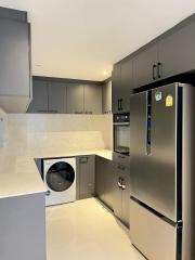 Modern kitchen with stainless steel appliances and built-in washing machine