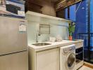 Modern kitchen with stainless steel appliances and city view