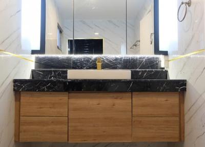 Modern bathroom with marble details and wooden vanity