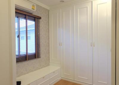 Bright bedroom with built-in wardrobes and window