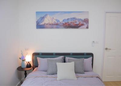 Cozy bedroom with queen-size bed and decorative artwork