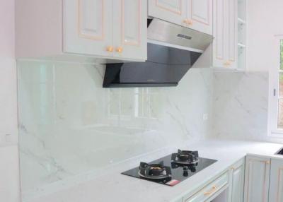 Modern kitchen with stainless steel appliances and white cabinetry