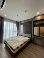 Spacious bedroom with large bed, wooden flooring, and ample natural light