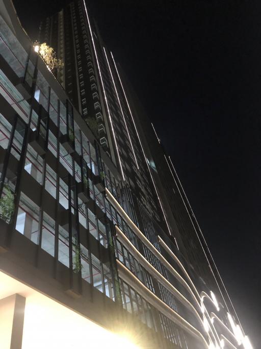 Modern high-rise residential building exterior at night