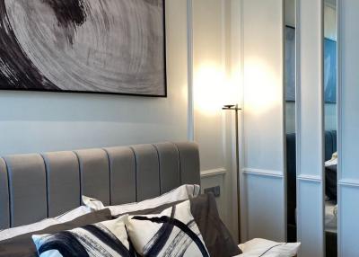 Elegant bedroom with decorative artwork and stylish headboard