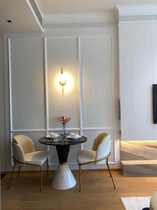 Elegant modern dining area with wall-mounted lighting fixture