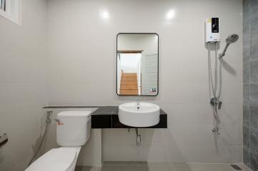 Modern bathroom with white tiles and essential fittings