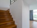 Modern staircase with wooden steps leading to the upper floor of a house