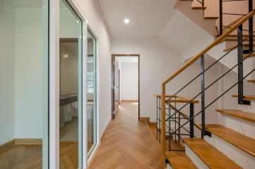 Modern hallway interior with staircase and sliding glass doors