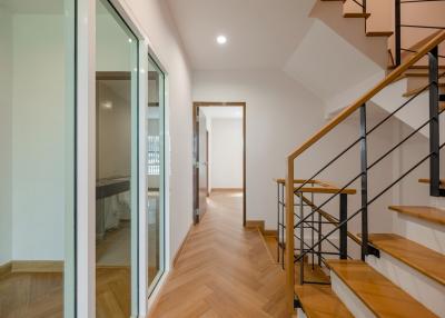 Modern hallway interior with staircase and sliding glass doors