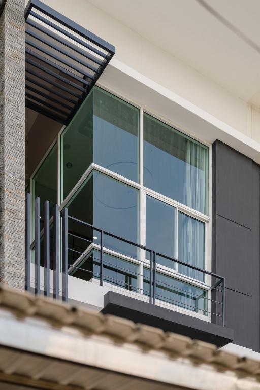 Modern building facade with large windows and balcony