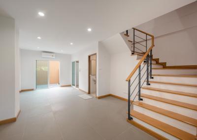 Spacious and bright empty interior with staircase