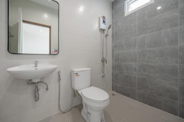 Modern bathroom with grey tiles and white fixtures