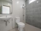 Modern bathroom with grey tiles and white fixtures