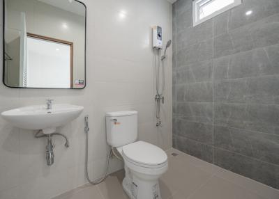 Modern bathroom with grey tiles and white fixtures