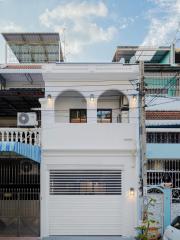 Modern two-story residential building facade with garage door