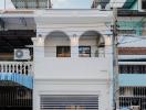 Modern two-story residential building facade with garage door