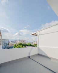 Spacious balcony with a wide-open sky view and cityscape