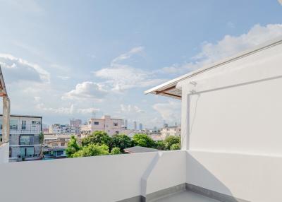 Spacious balcony with a wide-open sky view and cityscape